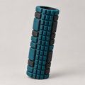 Deep teal and black textured foam roller with grid surface