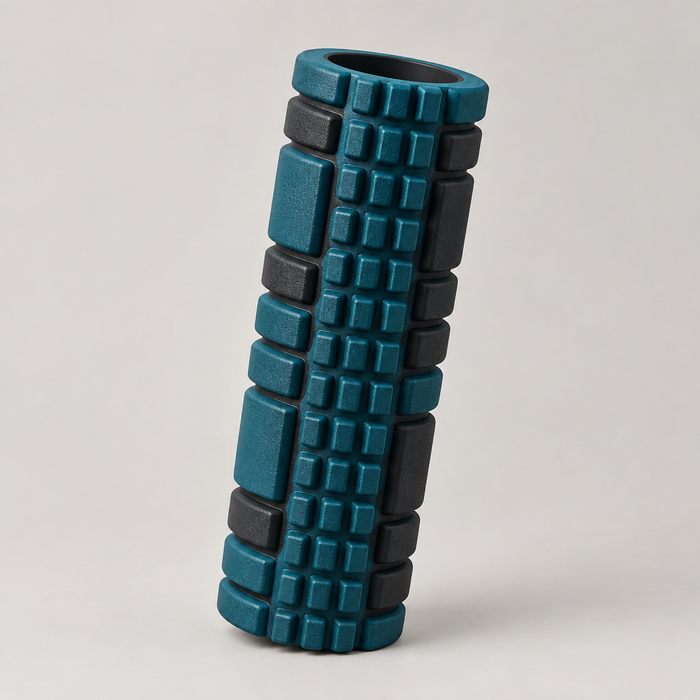 Deep teal and black textured foam roller with grid surface